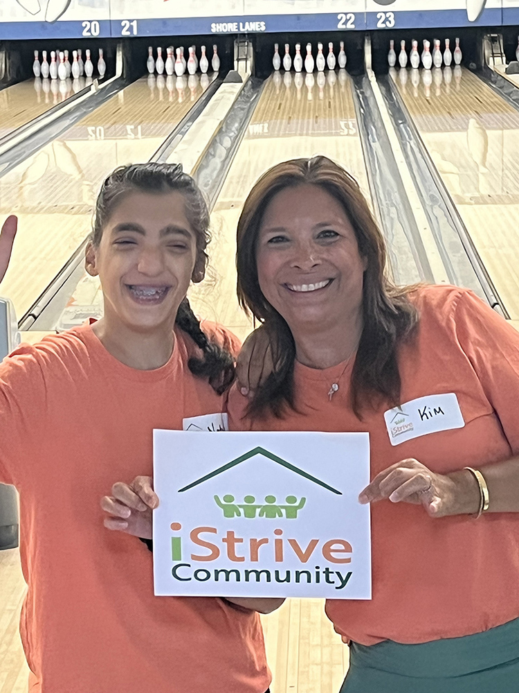 People with special needs at the iStrive Community's "Friday Night Bowling and Pizza" event.