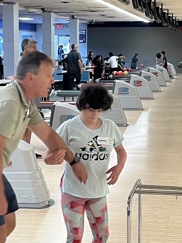 People with special needs at the iStrive Community's "Friday Night Bowling and Pizza" event.