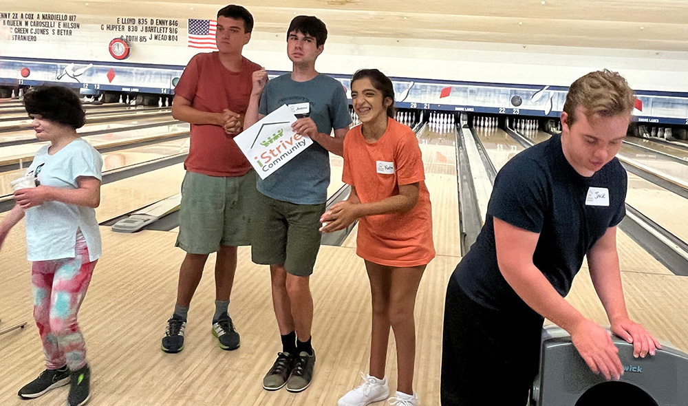 People with special needs at the iStrive Community's "Friday Night Bowling and Pizza" event.